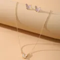 Close-up of elegant butterfly pendant necklace and stud earrings jewelry set - Butterfly Style (52171HB) / Gold + White