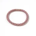 Macro view of high elasticity pink twisted hair tie featuring navy blue polka dots - Pink