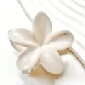 Close-up of elegant plumeria hair claw clip with white marble pearlescent finish - Pearl Texture Style (3577-3) / Cream White