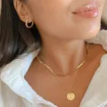 Elegant minimalist gold layered necklace featuring snake chain and hammered round pendant - Double Hammered Disc Style (5686501)