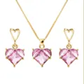 Macro view showing detail of Barbie pink heart-shaped crystal necklace and earrings set - Pink Heart (Gold Chain)