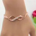 Elegante roségouden armband met oneindigheidssymbool en heldere strass-steentjes - Geluks-8 Gevlochten Armband / Roségoud Geluks-8