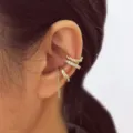 Set of 3 elegant gold-tone ear cuffs featuring sparkling stones and twisted designs - Gold Chain Dangle Style (5753601)