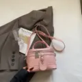 Fashionable pink leather box handbag with a top handle and adjustable shoulder strap. - Single Bag / Pink