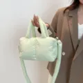 Stylish light green quilted puffer bag featuring a soft nylon texture and crossbody strap - Green