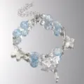 Detailed view of light blue crackle beads and silver butterfly charms on a luxury bracelet - Fresh Luxury Style (6107601) / Light Blue