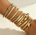 Set of stackable gold bangles featuring various textured, twisted and heart engraved designs - 12-Piece Set - Geometric Layering (6527501HB) / Gold
