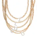 Meerlaagse kralenketting met schelp-letterhangers in een chique boho-stijl. - Letter A