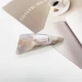 Close-up detail of the marble pattern resin hair clip with a modern geometric design. - Light Brown Fragmented (19)