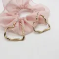 Macro detail shot of irregular gold heart-shaped earrings with a shiny metallic finish - Irregular Geometric Heart Shape (12)