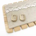 Detailed macro view of gold-tone U-shaped earrings with a unique textured finish - U-shaped Patchwork Texture (8) / Gold