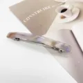Detailed view of a rectangular resin hair clip with elegant purple marble texture. - Rectangular Spring Clip (4) / Purple Gradient Marble