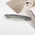 Grey resin rectangular barrette hair clip on a minimalist magazine background - Cloudy Gray Marble