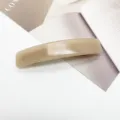 Close-up view of minimalist beige acetate rectangular spring hair clip on magazine prop - Light Khaki (4)