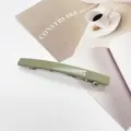 Detail view of a minimalist sage green resin rectangular barrette hair clip. - Sage Green