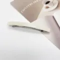 Close-up of minimalist cream white resin rectangular spring barrette hair clip design - Creamy Off-white