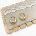 Detail view of chunky gold teardrop hoop earrings on a velvet display pad - Geometric Teardrop Style (9) / Gold