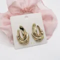 Macro detail of chunky irregular wavy gold earrings presented on a display card - Irregular Wavy Geometric (25)