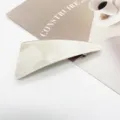 Detailed view of cream marble resin geometric hair clip with secure spring fastening - Off-White Marble (3)