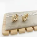 Detailed macro view of gold chunky hoop earrings featuring a geometric pleated design - Ribbed Pleated Texture (10) / Gold