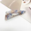 Close-up of geometric marble resin hair clip with elegant blue and beige texture - Dark Blue Amber Mixed (1)