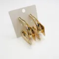 Oversized gold geometric earrings with abstract ocean-inspired design on white card - Irregular 3D Geometric Shape (19)