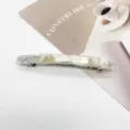 Close-up detail of a rectangular resin hair barrette with elegant white marble pattern - Blue and White Marble Texture