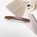 Close-up of minimalist brown resin hair clip with elegant rectangular barrette design - Dark Brown