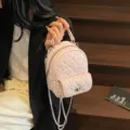 Elegant mini pink quilted backpack featuring shimmering rhinestones and silver chain straps - Pink