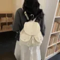 White minimalist star pattern backpack with drawstring flap for women school style - Off White