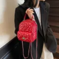 Red quilted mini backpack with rhinestone decor and silver chain strap. - Burgundy