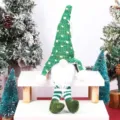 Christmas faceless doll hanging ornament featuring green knitted hat and striped long legs. - Green