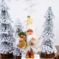 Close-up detail view of the gold and white plush Santa Claus figurine with snow trees decor. - 5 Inch Gold Printed Style