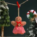 Detailed shot of cute felt gingerbread man hanging ornament with red checkered skirt. - Gingerbread Girl Female Ornament