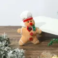 Detailed view of a cute knitted gingerbread man plush ornament for Christmas decor - Flat Gingerbread Man Pendant Chef Hat