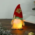 Detailed view of a glowing Christmas gingerbread gnome plush toy with warm LED light - Gingerbread Man Glowing Gnome Male