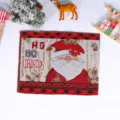 Detailed view of knitted Christmas placemat featuring Santa Claus and festive holiday text. - Style A Red Santa Claus