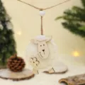 Close-up detail of a cute wooden and wool sheep hanging ornament with hemp rope for holiday decor. - White Fluffy Sheep