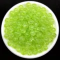 Macro view of unique ice crackle texture on 8mm lime green acrylic beads for DIY jewelry - Green