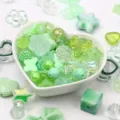Close-up of assorted green acrylic beads for DIY jewelry and crafts in a bowl - 500g Pack / Green
