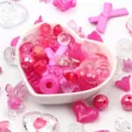 Macro view of mixed pink acrylic beads in heart-shaped bowl for DIY jewelry making - 500g Pack / Rose Red