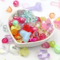 Detailed view of mixed colorful acrylic beads in heart-shaped bowl for DIY jewelry - 500g Pack / Multicolor
