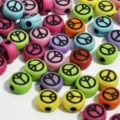 Close-up of 7mm colorful acrylic beads with black peace sign symbols for DIY jewelry. - 3800 Pieces/Pack (4x7mm) / Colored Base Black Letters