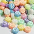 Detailed macro shot of 7mm colorful acrylic beads featuring a white engraved peace sign - 3800 Pieces/Pack (4x7mm) / Colored Base White Letters