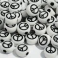 Detailed macro view of white 7mm acrylic beads with black peace symbol designs - 3800 Pieces/Pack (4x7mm) / White Base Black Bow