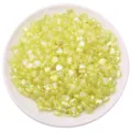 Iridescent lime green heart-shaped acrylic beads for DIY jewelry making on white plate - Heart Shape / 100 Pieces Pack (8x9mm) / Yellow