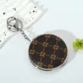 Detailed view of portable folding makeup mirror keychain with vintage floral pattern - Style 2 (Dark Brown Vintage Floral)