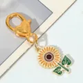 Close-up view of sunflower keychain with gold heart-shaped clasp and green leaves - Small Round Sunflower