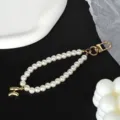 Close-up of elegant pearl keychain with gold-plated letter H charm and sturdy metal clasp - Letter H(H)