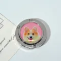 Macro view of portable foldable metal bag hook with a cute corgi dog illustration - Pink Corgi Style